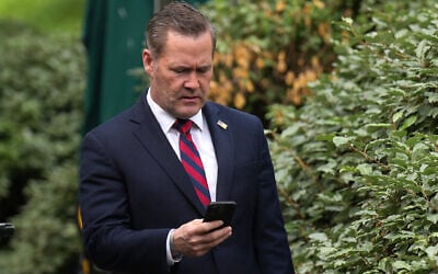 National Security Adviser Michael Waltz looks at his phone as he prepares for a TV interview at the White House on May 1, 2025, in Washington, DC. (Andrew Harnik / GETTY IMAGES NORTH AMERICA/AFP)