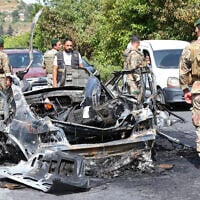 Lebanese army soldiers stand next to a destroyed car that was targeted in an Israeli drone strike in Abu al-Aswad in southern Lebanon on May 17, 2025. . (Photo by Mahmoud ZAYYAT / AFP)