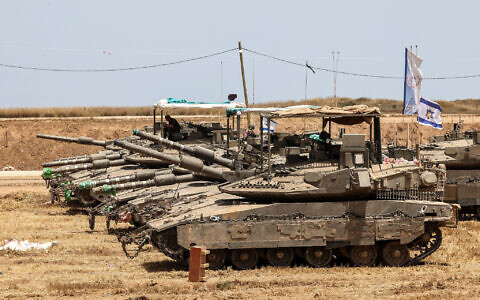 This picture taken from a position in southern Israel shows Israeli tanks deployed on the border with the Gaza Strip on May 17, 2025. (Jack GUEZ / AFP)