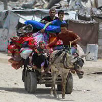 Palestinians move with their belongings as they flee the northern cities of Jabalia and Beit Lahia Gaza Strip towards Gaza City amid continuous Israeli strikes in the besieged Palestinian enclave on May 17, 2025. (Bashar Taleb/AFP)