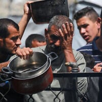 Palestinians react after food runs out at a charity kitchen providing hot meals in Jabaliya, in the northern Gaza Strip on May 17, 2025. (Bashar Taleb/AFP)
