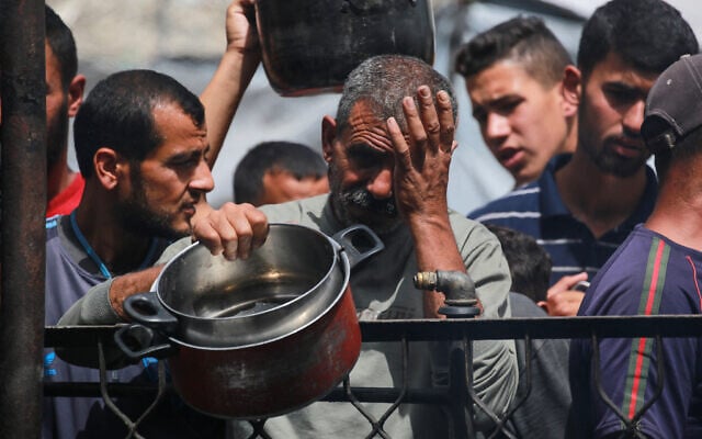 Palestinians react after food runs out at a charity kitchen providing hot meals in Jabaliya, in the northern Gaza Strip on May 17, 2025. (Bashar Taleb/AFP)