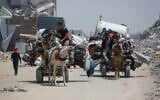 Palestinians move with their belongings as they flee the northern cities of Jabalia and Beit Lahia Gaza Strip towards Gaza City amid continuous Israeli strikes in the besieged Palestinian territory on May 17, 2025. (Bashar TALEB / AFP)