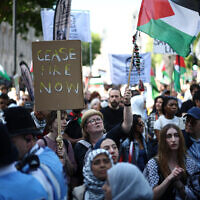Pro-Palestinian, anti-Israel protesters gather on Whitehall after a march through central London, on May 17, 2025, calling for a "Free Palestine" and an end to "the Genocide," as they commemorate the 77th anniversary of the "Nakba." (Photo by HENRY NICHOLLS / AFP)
