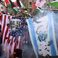 Protesters burn US and Israeli flags during a demonstration against Israel's participation in the Eurovision Song Contest 2025 in Basel, on May 17, 2025. (Sebastien Bozon/AFP)
