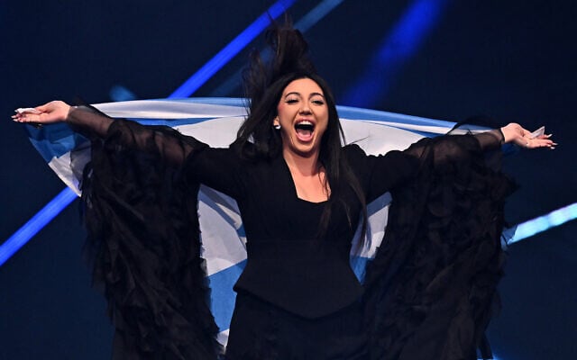 Israeli singer Yuval Raphael parades during the flag ceremony at the grand final of the Eurovision Song Contest 2025, at the St. Jakobshalle arena in Basel on May 17, 2025. (Fabrice COFFRINI / AFP)