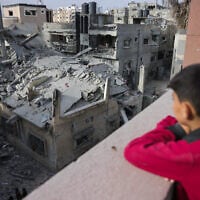 A Palestinian boy looks at a house destroyed in Israeli strikes in al-Saftawi area west of Jabalia in the northern Gaza Strip on May 18, 2025. (Bashar TALEB / AFP)
