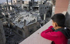A Palestinian boy looks at a house destroyed in Israeli strikes in al-Saftawi area west of Jabalia in the northern Gaza Strip on May 18, 2025. (Bashar TALEB / AFP)