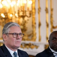 Britain's Prime Minister Keir Starmer and Britain's Foreign Secretary David Lammy attend a meeting between the UK and the European Union to discuss closer ties in their first official summit since Brexit, in London on May 19, 2025. (Kin Cheung / POOL / AFP)