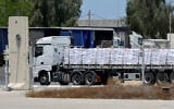 A truck carrying aid enters the Gaza Strip from the Israeli Kerem Shalom crossing, on May 20, 2025. (Jack GUEZ / AFP)