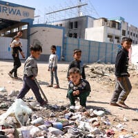 Children play around waste in front of the closed UN agency for Palestinian refugees UNRWA headquarters in Gaza City, on May 20, 2025. (Bashar TALEB / AFP)