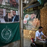 A man rides a motorbike in a narrow alleyway at the Burj al Barajneh camp for Palestinian refugees in Beirut's southern suburbs on May 20, 2025. (Joseph EID / AFP)