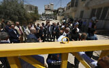 Members of a diplomatic delegation from the European Union stand behind a gate at the eastern entrance of Jenin camp during a visit to the city of Jenin, on May 21, 2025. (Mohammad MANSOUR / AFP)