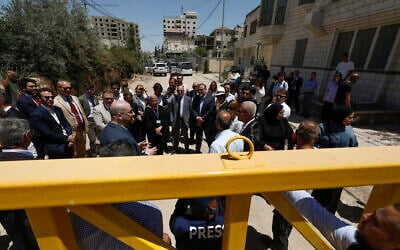 Members of a diplomatic delegation from the European Union stand behind a gate at the eastern entrance of Jenin camp during a visit to the city of Jenin, on May 21, 2025. (Mohammad MANSOUR / AFP)