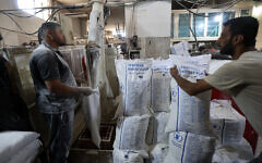 Employees work inside a bakery in Deir el-Balah in the central Gaza Strip, after Israel allowed limited humanitarian aid to enter the Palestinian territory on May 22, 2025.(Eyad BABA / AFP)