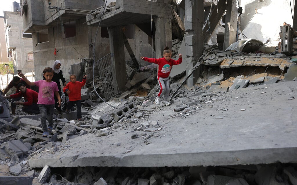 Palestinian children walk amid the rubble following Israeli strikes in Jabaliya's Saftawi neighborhood in the northern Gaza Strip on May 22, 2025. (Bashar Taleb/AFP)