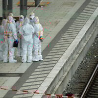 Forensic police officers investigate on the railway platform at the main train station in Hamburg, Germany, where at least 12 people have been injured in a knife attack, May 23, 2025. (Jonas Walzberg / AFP)