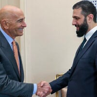 This handout photograph taken and released by Turkish Foreign Ministry press service on May 24, 2025, shows US Ambassador to Turkey Thomas Barrack (L) shakes hands with Syria's interim President Ahmed al-Sharaa (R) during a meeting in Istanbul. (Handout / Turkish Foreign Ministry, AFP)