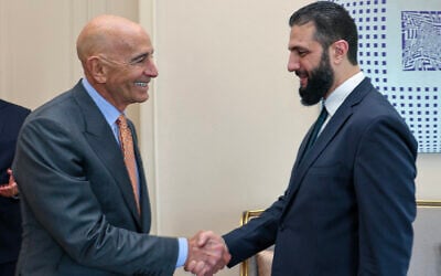 This handout photograph taken and released by Turkish Foreign Ministry press service on May 24, 2025, shows US Ambassador to Turkey Thomas Barrack (L) shakes hands with Syria's interim President Ahmed al-Sharaa (R) during a meeting in Istanbul. (Handout / Turkish Foreign Ministry, AFP)