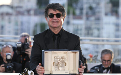 Iranian director Jafar Panahi poses with the trophy during a photocall after winning the Palme d'Or for the film, 'Un simple accident' (A Simple Accident) during the closing ceremony at the 78th edition of the Cannes Film Festival in Cannes, southern France, on May 24, 2025. (Miguel Medina/AFP)