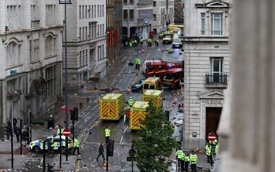 Police officers investigate the scene of an incident in Water Street, on the sidelines of an open-top bus victory parade for Liverpool's Premier League title win, in Liverpool, north-west England on May 26, 2025. (Photo by Darren Staples / AFP)