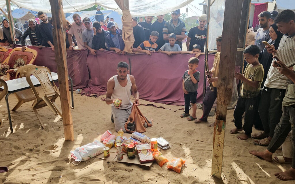 Displaced Palestinians receive food packages from a US-backed humanitarian aid distribution center in Rafah, in the southern Gaza Strip on May 27, 2025. (Photo by AFP)