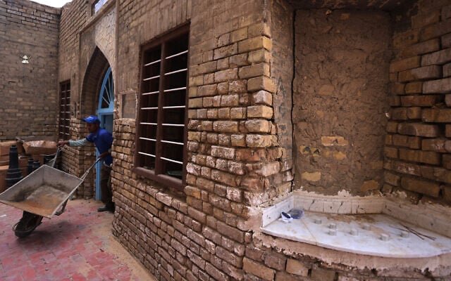 Iraqi workers restore the centuries-old shrine of Rabbi Isaac Gaon in central Baghdad's al-Kifah neighborhood on April 21, 2025. (AHMAD AL-RUBAYE / AFP)