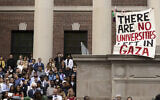 A protester holds a sign reading 'There are no universities left in Gaza' amid the commencement ceremony on May 29, 2025, in Cambridge, Massachusetts. (Libby O'Neill / Getty Images via AFP)