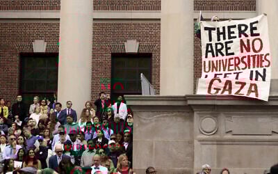 A protester holds a sign reading 'There are no universities left in Gaza' amid the commencement ceremony on May 29, 2025, in Cambridge, Massachusetts. (Libby O'Neill / Getty Images via AFP)