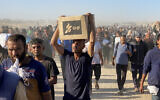 Displaced Palestinians carrying relief supplies from the Gaza Humanitarian Foundation (GHF), a private US-backed aid group, return from aid distribution centers in Rafah to their tents in the southern Gaza Strip on May 29, 2025. (Photo by AFP)