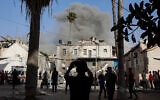 This picture taken from the grounds of the Ahli Arab Hospital, also known as the Maamadani Hospital, shows a cloud of smoke erupting following Israeli bombardment on a building in the Daraj neighborhood of Gaza City on May 31, 2025. (Omar al-Qattaa/AFP)