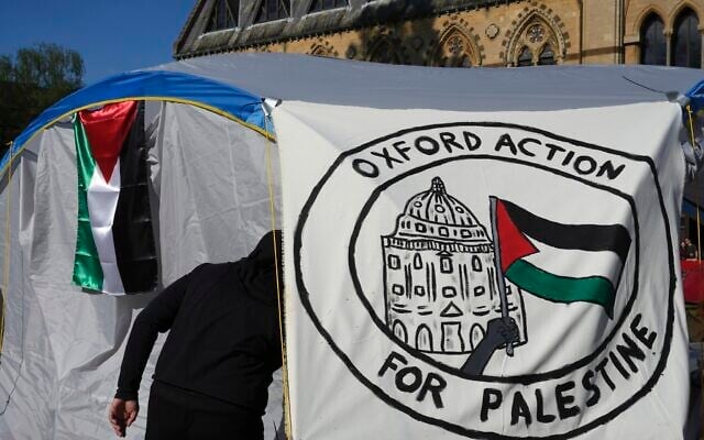 A pro-Palestinian student walks in a tent outside the Pitt Rivers Museum in Oxford, England, Thursday, May 9, 2024. (AP Photo/Kin Cheung) A pro-Palestinian student walks in a tent outside the Pitt Rivers Museum in Oxford, England, Thursday, May 9, 2024. (AP Photo/Kin Cheung)