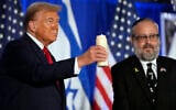 Then-Republican presidential nominee President Donald Trump lights a candle with Rabbi Yehuda Kaploun at an event marking one year since the October 7 Hamas atrocities, October 7, 2024, in Miami. (AP Photo/Alex Brandon)