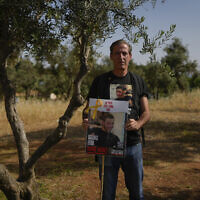 Ruby Chen holds a poster of his son, Itay Chen, during a protest near the Knesset in Jerusalem, on March 9, 2024. (AP Photo/Ohad Zwigenberg, File)