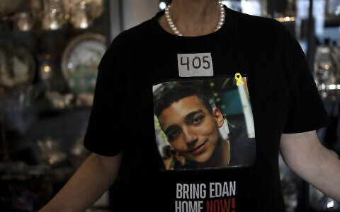 Varda Ben Baruch, whose grandson Edan Alexander is held hostage in the Gaza Strip by Hamas terrorists, wears tape marking the days since his capture, at home in Tel Aviv, November 14, 2024. (AP Photo/Maya Alleruzzo)