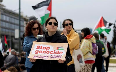 A pro-Palestinian, anti-Israel protester holds a placard during a rally against Israel in Athens, Greece, on Sunday, March 23, 2025. (AP/Yorgos Karahalis)