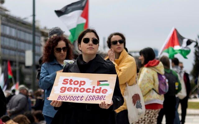 A pro-Palestinian, anti-Israel protester holds a placard during a rally against Israel in Athens, Greece, on Sunday, March 23, 2025. (AP/Yorgos Karahalis)