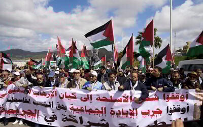 Moroccans protest the docking of a Maersk cargo ship carrying airplane parts they suspect are headed to Israel, outside Tangier Med Port on April 20, 2025. Banner in Arabic reads "Stop shipping weapons to the terrorist Zionist entity." (AP Photo/Mosa'ab Elshamy)