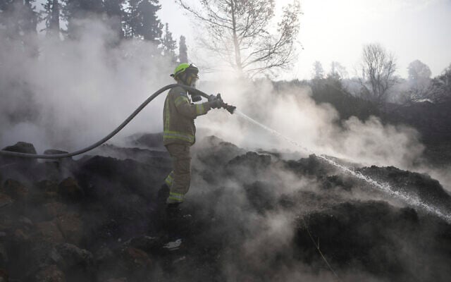 An Israeli firefighter battles a wildfire near Latrun, Israel, outside of Jerusalem, May 1, 2025. (AP/Ohad Zwigenberg)