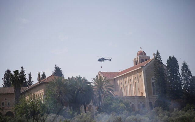 An Israeli fire helicopter flies over the Roman Catholic Trappist monastery where fire crew is battling a wild fire in Latrun, Israel, outside of Jerusalem Thursday, May 1, 2025. (AP Photo/Ohad Zwigenberg) An Israeli fire helicopter flies over the Roman Catholic Trappist monastery where fire crew is battling a wild fire in Latrun, Israel, outside of Jerusalem Thursday, May 1, 2025. (AP Photo/Ohad Zwigenberg)