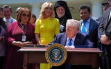 President Donald Trump, surrounded by religious leaders, signs an executive order establishing the Religious Liberty Commission, during a National Day of Prayer event in the Rose Garden of the White House, May 1, 2025. (AP/Evan Vucci)