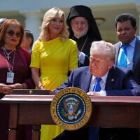 President Donald Trump, surrounded by religious leaders, signs an executive order establishing the Religious Liberty Commission, during a National Day of Prayer event in the Rose Garden of the White House, May 1, 2025. (AP/Evan Vucci)