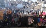 Palestinians wait for donated food at a distribution center in Beit Lahiya, northern Gaza, March 16, 2025. (AP Photo/Abdel Kareem Hana,File)