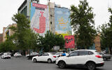 Vehicles drive past an anti-Israel banner showing numerous locations in Israel as a Yemeni dagger (jambiya) with writing in Farsi reading: "All targets are within range, Yemeni missiles for now!" and in Hebrew "All targets are within reach, we will choose," in Tehran, Iran, May 5, 2025. (AP Photo/Vahid Salemi)