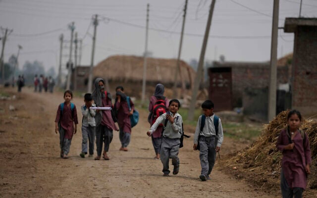 Indian students walk home after attending school near international border India Pakistan at Jora farm village, in Ranbir Singh Pura about 35 kilometers (22 miles) from Jammu, India, Tuesday, May 6, 2025. (AP Photo/Channi Anand)
