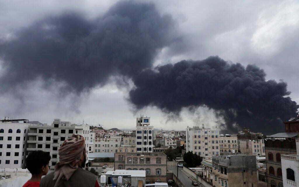 Yemenis watch as smoke billows following Israeli airstrikes targeting a power plant and Sanaa Airport, in Sanaa, Yemen, May 6, 2025. (AP Photo/Osamah Abdulrahman)