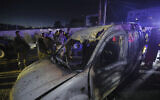 Lebanese army soldiers and rescue workers gather next to a damaged car after an Israeli strike, in the southern port city of Sidon, Lebanon, early Wednesday, May 7, 2025. (AP/Mohammed Zaatari)