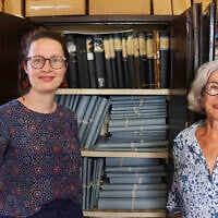 Rosa de Jong, left, and Lilly Duijm pose in front of the boxes of documents from the archive in Paramaribo, Suriname, May 2, 2025. (Oscar Keur/AP)