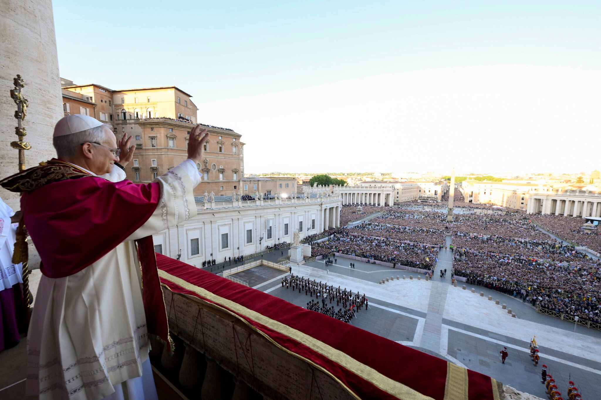 arafed pope waves to the crowd from the balcony of st peter ' s basilica