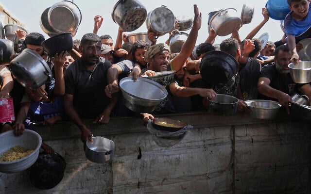 Palestinians struggle to obtain donated food at a community kitchen in Khan Younis, in the southern Gaza Strip, Friday, May 9, 2025. (AP Photo/Abdel Kareem Hana) Palestinians struggle to obtain donated food at a community kitchen in Khan Younis, in the southern Gaza Strip, Friday, May 9, 2025. (AP Photo/Abdel Kareem Hana)